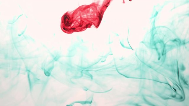 Red Ink on white background floating on water. Tattoo artist cleaning his tool on water after completing a tattoo. 4k video, Different colors in gallery