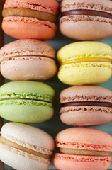 assortment of macaroon cookies on wooden surface