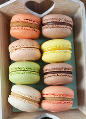 assortment of macaroon cookies on wooden surface