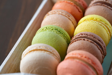 assortment of macaroon cookies on wooden surface