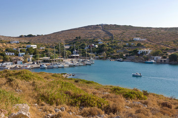 Arki island, sailing boats in the small harbor surrounded by taverns,  Dodecanese Islands, Greece