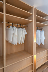 White woman clothes in wooden wardrobe or the closet interior decoration modern home