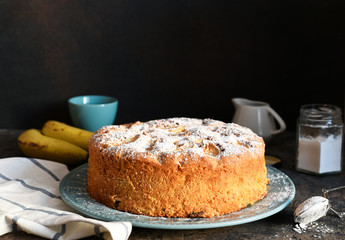 Charlotte - a classic pie with apples on a concrete background.