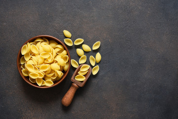 Pasta in a plate on a concrete dark background. Top view copy space.