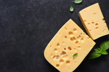 Radamer cheese on a black concrete background. View from above.