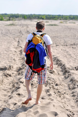 young man walking on the beach