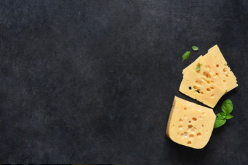 Radamer cheese on a black concrete background. View from above.