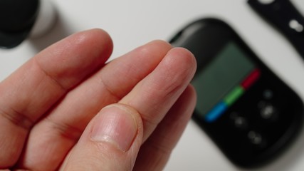 CLOSE UP: Man Makes A Self-Testing For Diabetes With Blood Glucose Test