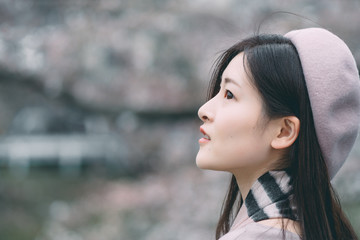 Under the cherry tree, the girl smiles gently