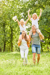 Kinder reiten huckepack und jubeln