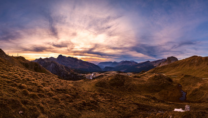 Evening twilight autumn alpine Dolomites mountain scene, Trento, Italy. View from Lake or Laghetto Baita Segantini.