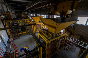 Industrial photography. A press machine for the manufacture of bricks from natural stone. Brick and block production