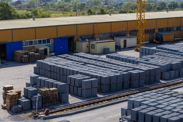 Industrial photography. General view of the warehouse of natural stone pressed into brick under the...