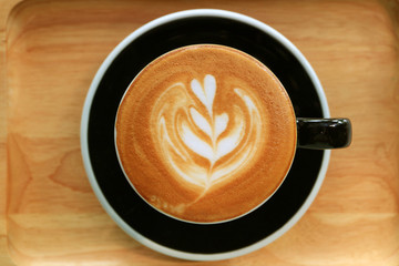 Top view of a cup of cappuccino coffee with beautiful latte art
