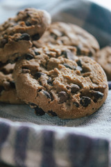 American chocolate cookies on blue cloth prepared for breakfast in the morning sunlight.