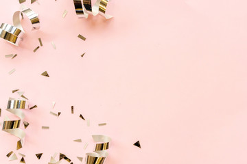close up on group of silver color of rolling ribbon and confetti on pink background with copy space for valentine's day ,carnival , birthday and anniversary, concept design	