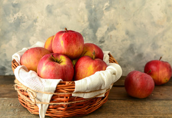 Red apples in a basket. Ripe apples in a wicker basket.