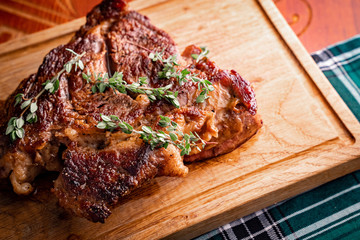 A ready Hot steak with rosemary on a wooden Board