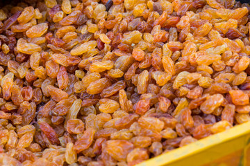 A large amount of yellow-brown raisins, texture.