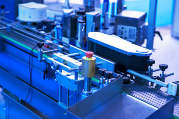 pharmaceutical industry. Production line machine conveyor at factory with bottles