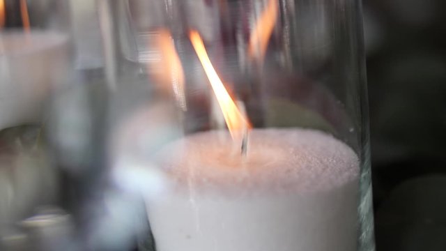 Burning candle in glass. Candle flame.