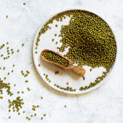 Dried mung beans on a plate with a spoon