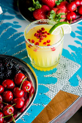 Frozen tropical cocktails. Traditional classic Hawaiian or tiki bar tropical drinks. Drinks w/  dark aged rum, blanco tequila, amaretto, garnished w/ limes pineapple cherries coconuts served frozen.
