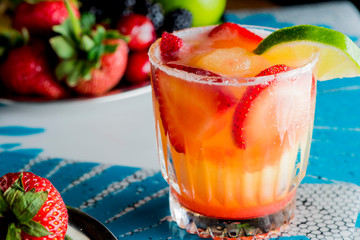 Frozen tropical cocktails. Traditional classic Hawaiian or tiki bar tropical drinks. Drinks w/  dark aged rum, blanco tequila, amaretto, garnished w/ limes pineapple cherries coconuts served frozen.