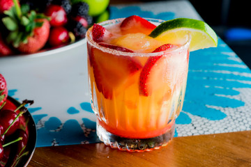Frozen tropical cocktails. Traditional classic Hawaiian or tiki bar tropical drinks. Drinks w/  dark aged rum, blanco tequila, amaretto, garnished w/ limes pineapple cherries coconuts served frozen.