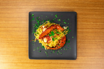 Plato de pasta de marisco picante sobre tabla de madera