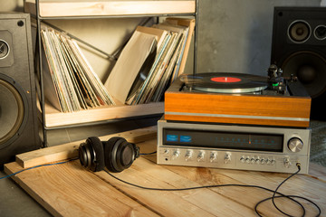 HiFi system with turntable, amplifier, headphones and lp vinyl records in a listening room