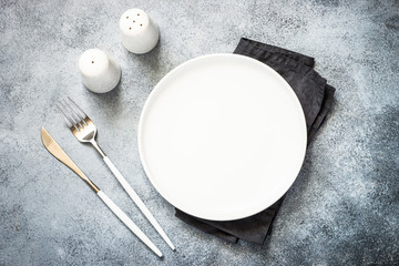 Cutlery set at stone kitchen table top view.