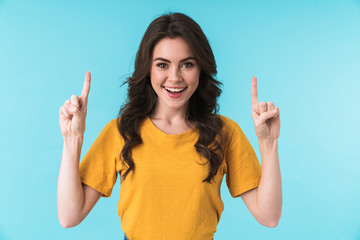 Positive young pretty woman pointing.