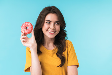 Optimistic positive young pretty woman holding donut.