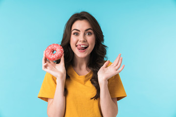 Optimistic positive young pretty woman holding donut.