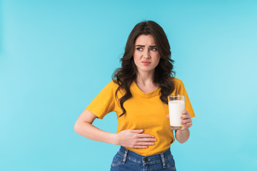 Beautiful woman with stomache holding milk.