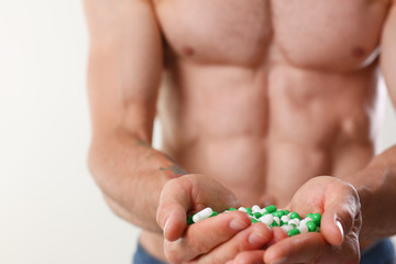 Athlete bodybuilder takes dope in the form of tablets form of pharma rapid progress in muscle development