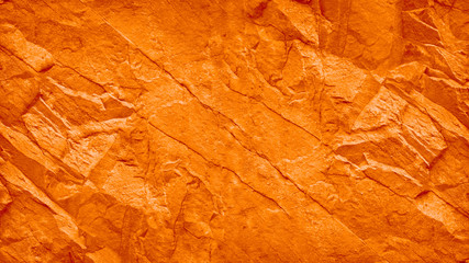 Red orange grunge background. Toned stone texture. Mountain texture close-up. lush lava color trend...