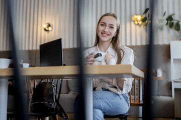 Young businesswoman on a coffee break. Using tablet computer
