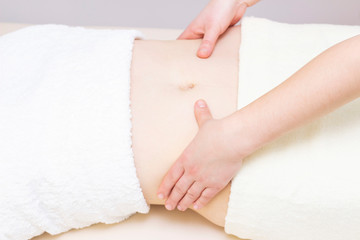 Massage Therapist Massaging a Womens Stomach. Massage and body care. Spa body massage woman hands treatment.