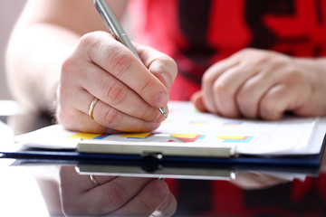 Male arm fill form clipped to pad with silver pen closeup. Sign gesture, read pact, sale agent, bank job, make note, loan credit mortgage investment, finance chief, legal law concept