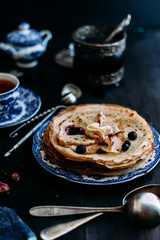 Pancakes with wild berries in a plate