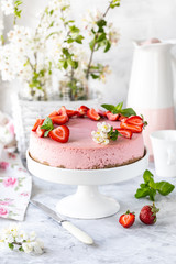 Obraz na płótnie Canvas Cheesecake with fresh strawberries on a white table. Selective focus