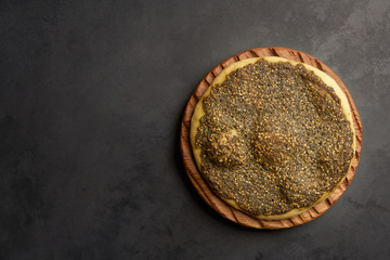 Zaatar manakeesh on black stone background  . Top view with copy space 