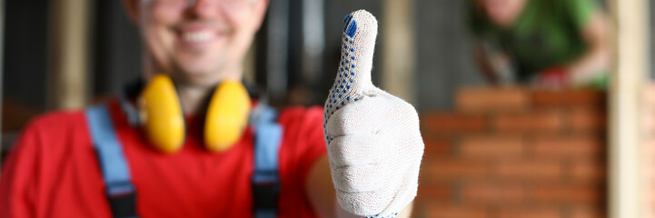 Happy smiling male worker showing thumb up gesture