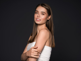 Fototapeta premium Beautiful healthy teeth smile woman natural skin hair Studio shot of a beautiful young woman posing against a