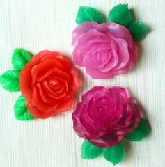 Handmade soap in the shape of roses on a wooden background 