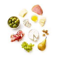 A set of tasty appetizers. Cheese plate with sliced brie, cheddar and parmesan, cured meat. Isolated on white background