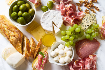 Big plate of appetizers for party of breakfast. Set of gourmet cheese and meat. Overhead view
