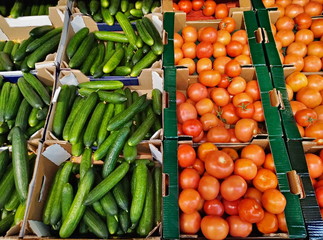 Cucumbers tomatoes on shelves in a supermarket